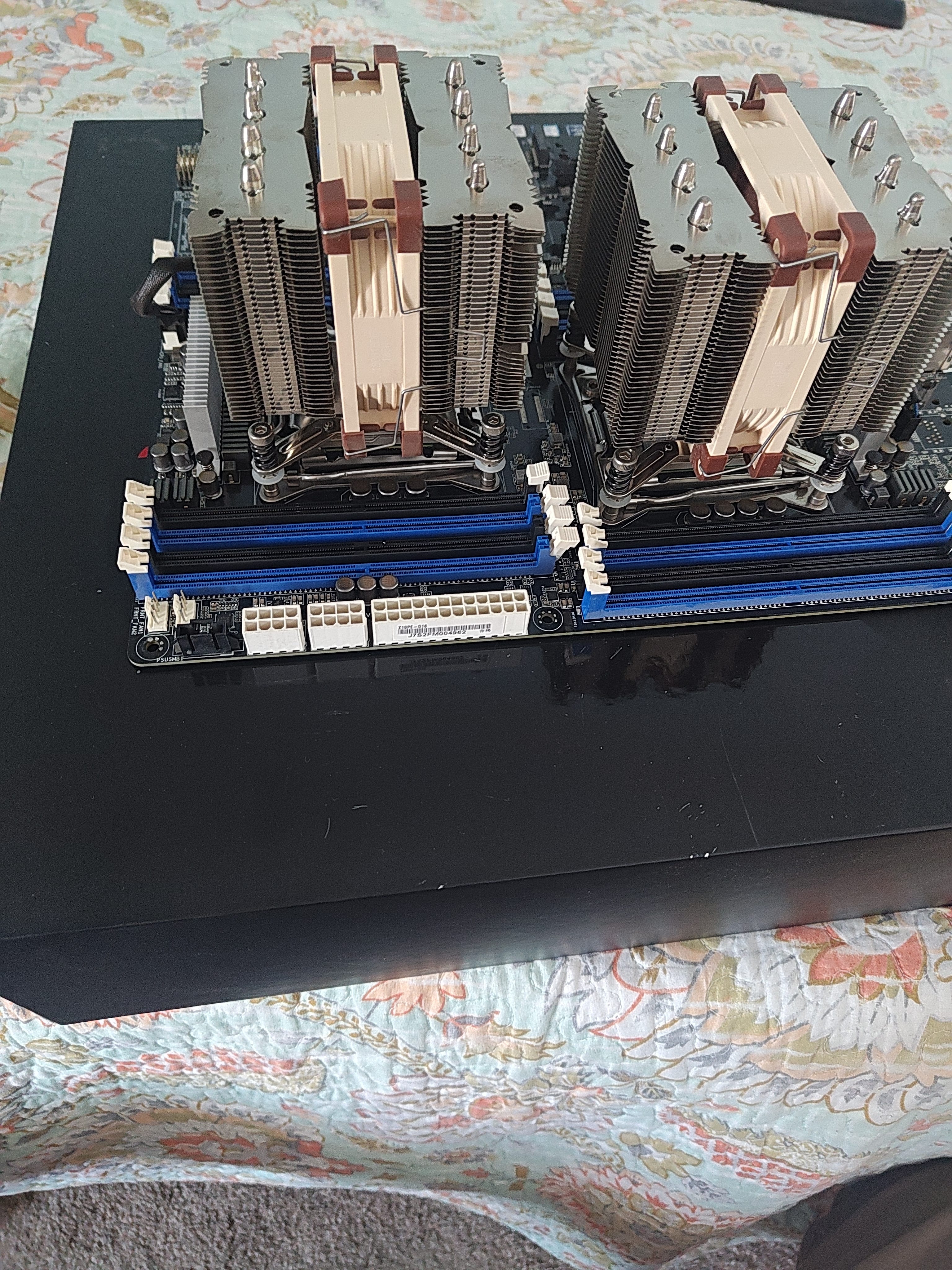 Top-down view of both Noctua coolers showing CPU power connectors between them