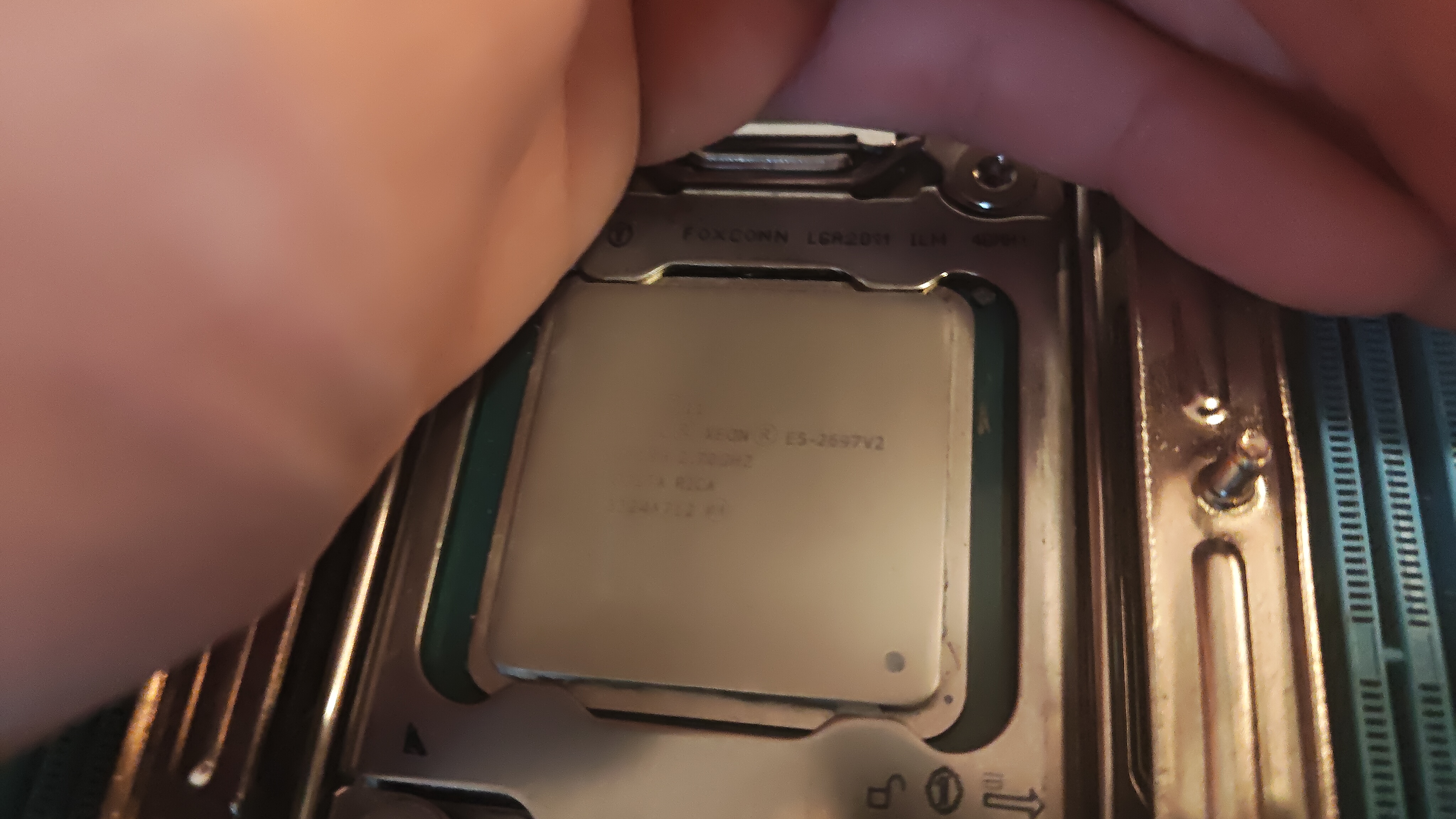 Close-up of an E5-2697 being seated into the LGA 2011 socket