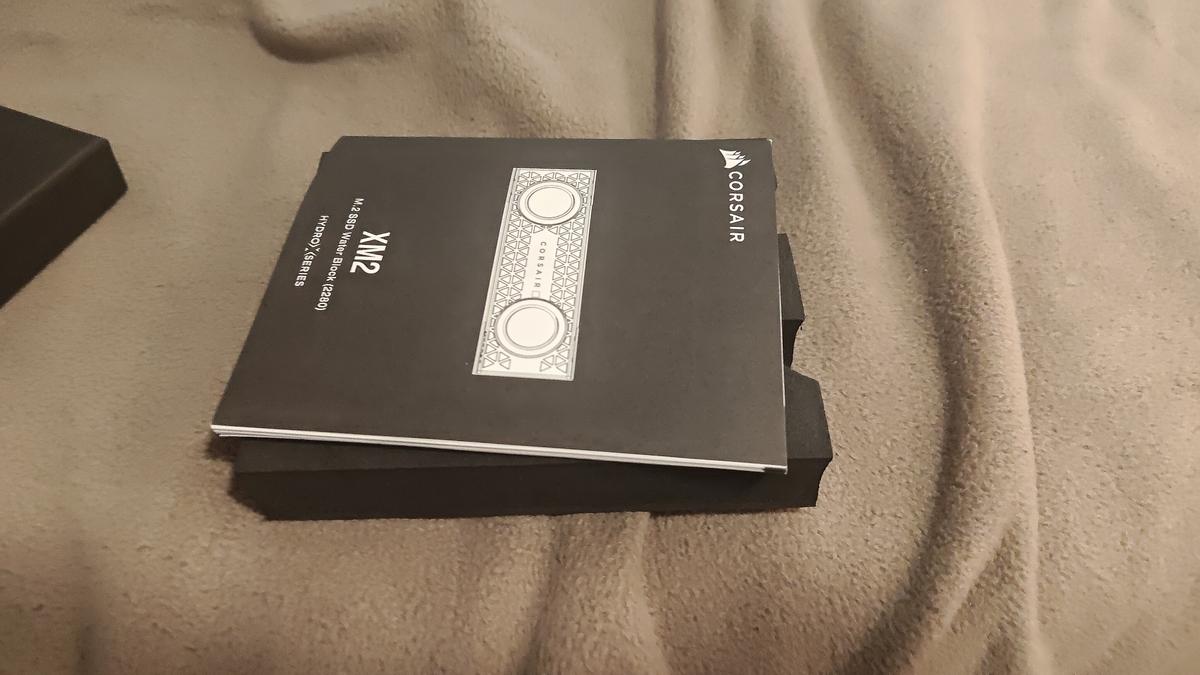 Samsung 980 1TB seated in Corsair XM2 bottom casing, fully open view