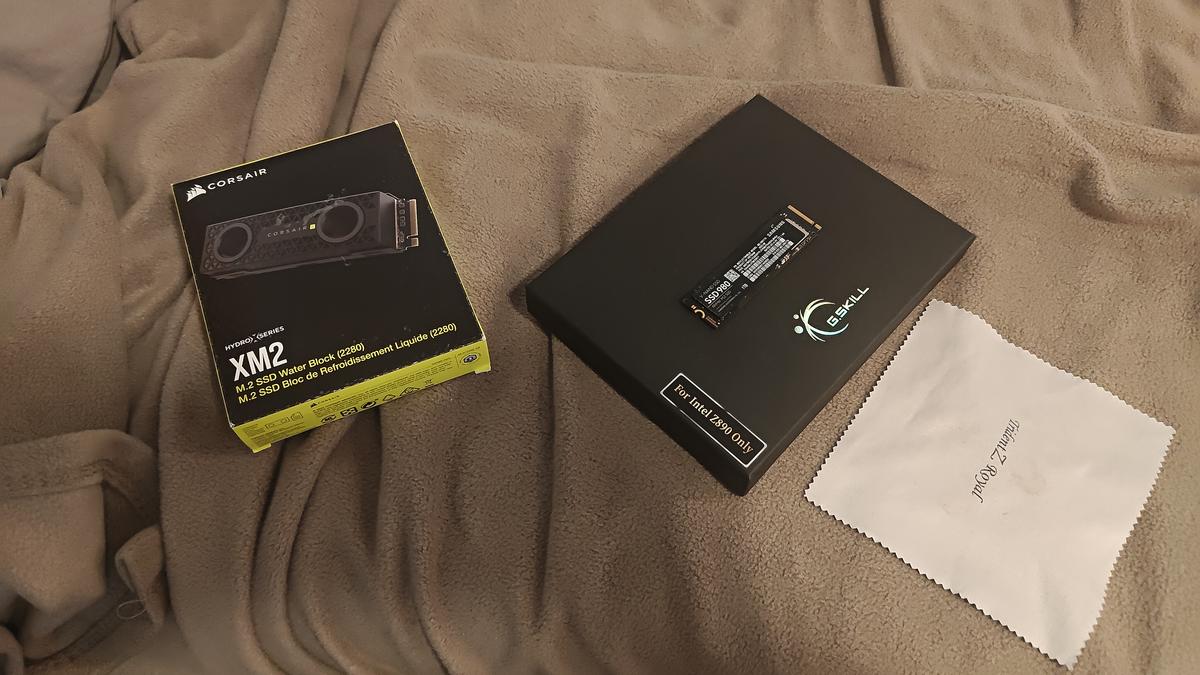 Corsair XM2 M.2 waterblock — sealed retail packaging on workbench