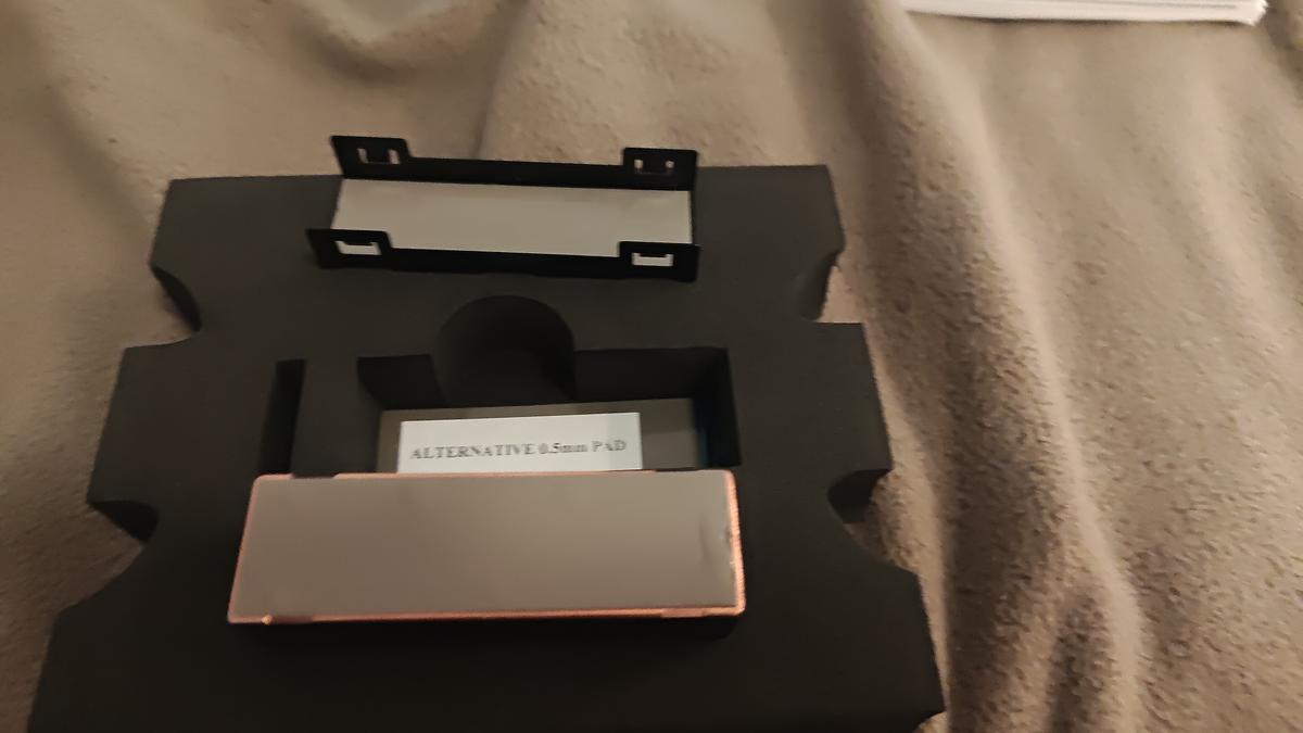 Corsair XM2 waterblock — protective film and thermal pads being removed
