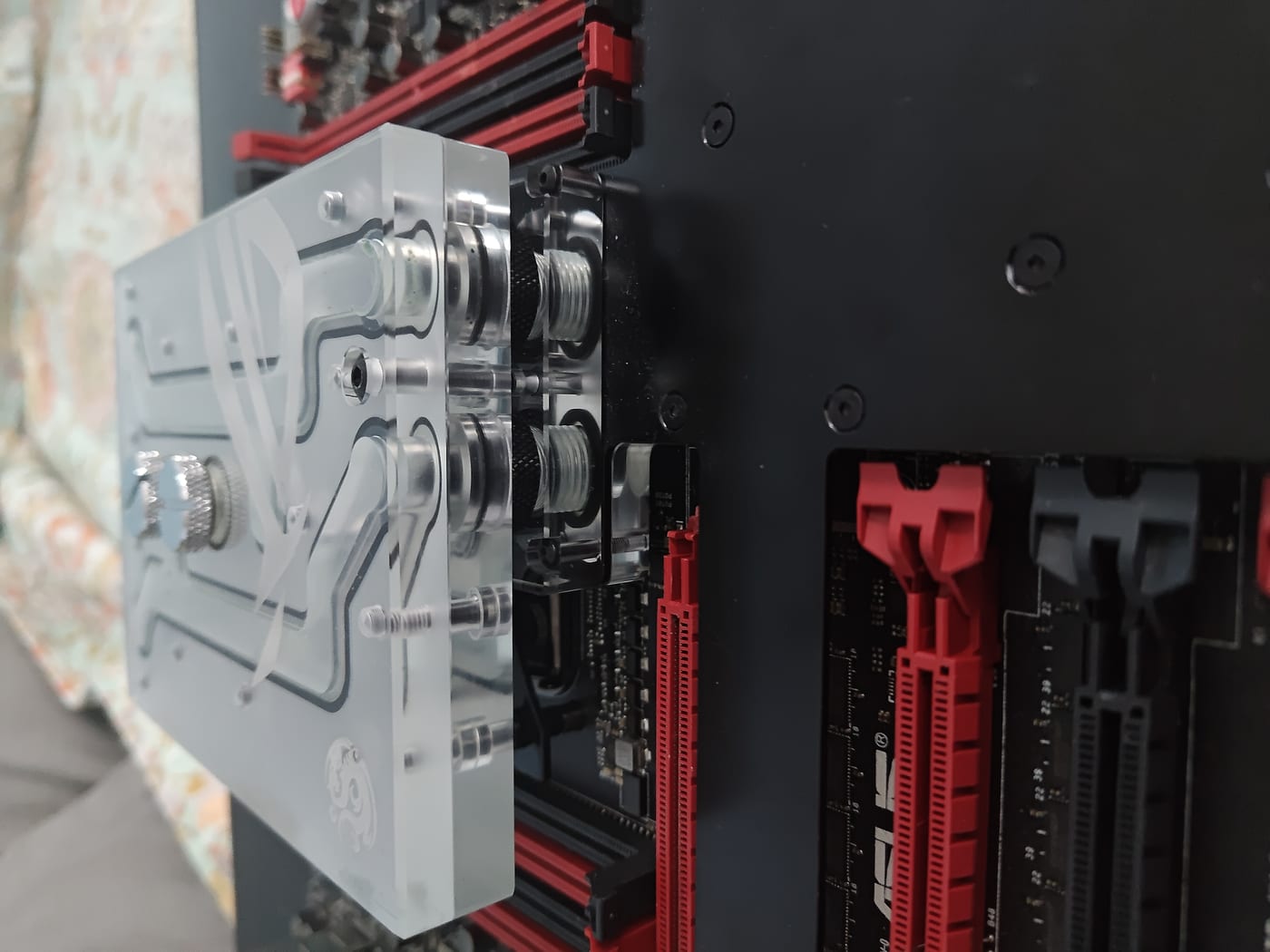 Chipset section of the monoblock — internal copper channels visible through clear acrylic top, junction between CPU and chipset blocks