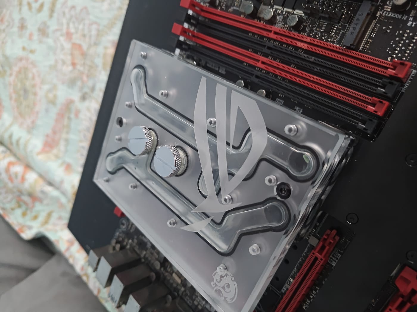 Bitspower ROG Certified monoblock — clear acrylic top with ROG eye logo engraved, chrome G1/4 fittings, full monoblock in detail