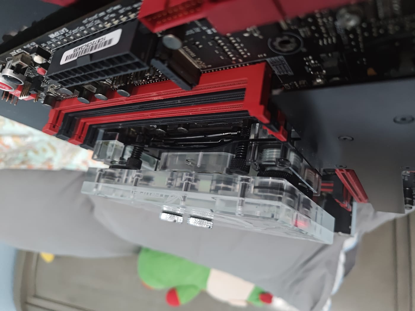 Side view of the full Bitspower monoblock assembly — CPU block, VRM extension, and chipset block connecting across the board