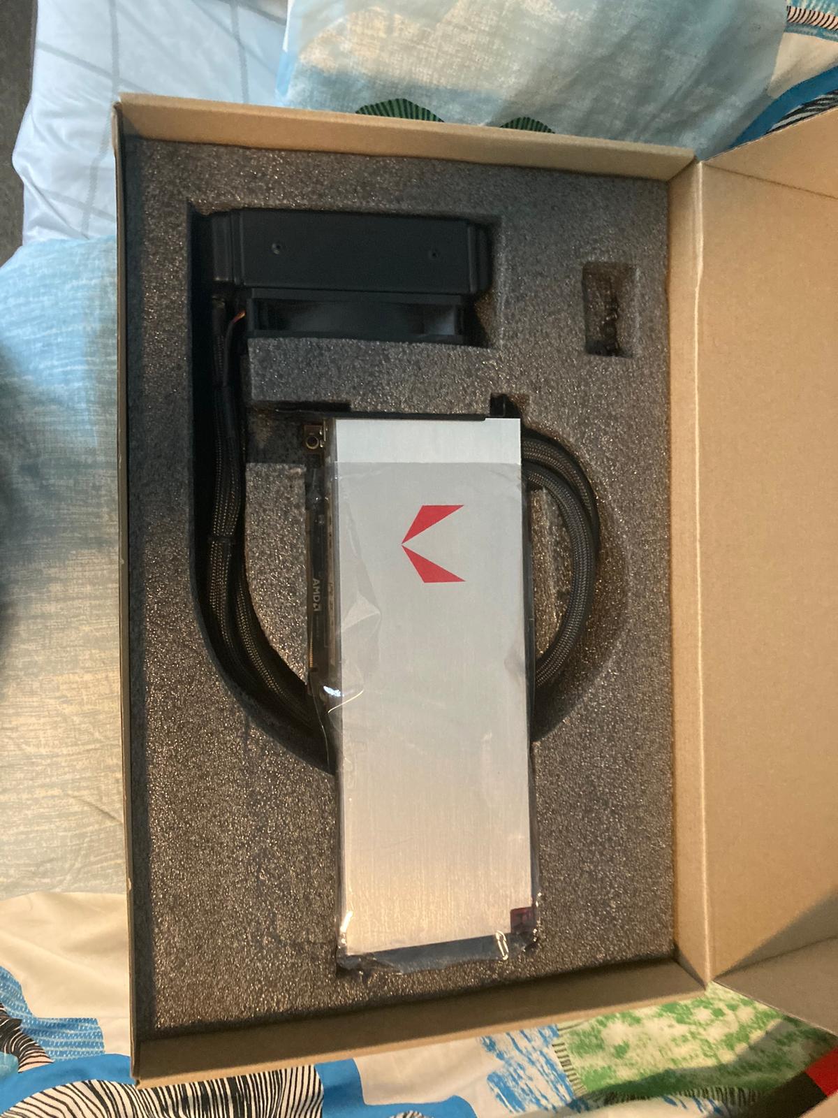 Vega 64 LC in foam packaging — silver shroud, AIO pump head